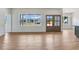 Open-concept living room featuring hardwood floors, large windows, and a double door entrance at 9235 Bear Run Ln, Middlesex, NC 27557