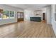 Open-concept living room featuring hardwood floors, a kitchen view, and plenty of natural light at 9235 Bear Run Ln, Middlesex, NC 27557