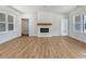 Spacious living room with wood floors, a decorative fireplace, and bright windows at 9235 Bear Run Ln, Middlesex, NC 27557