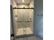 Luxurious walk-in shower with glass enclosure and decorative tile, complemented by elegant bronze hardware at 9235 Bear Run Ln, Middlesex, NC 27557
