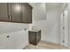 Functional laundry area featuring gray cabinetry, a sink, and wood-look flooring for added convenience at 95 Hornbeam Rd, Youngsville, NC 27596