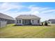 Backyard features lawn, screened in patio, and lush landscaping at 1 Parker Pond Ct, Durham, NC 27703
