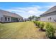 Backyard features lawn, landscaping, and a neighboring house at 1 Parker Pond Ct, Durham, NC 27703