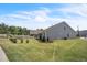 Spacious backyard featuring a well-manicured lawn, landscaping, and grey siding at 1 Parker Pond Ct, Durham, NC 27703