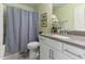 Bathroom featuring a vanity with gray counter and a shower with a striped shower curtain at 1 Parker Pond Ct, Durham, NC 27703