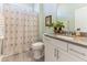 Bathroom featuring neutral tones, tiled floor, shower curtain and vanity at 1 Parker Pond Ct, Durham, NC 27703
