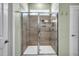 Walk-in shower with modern glass door, tiled walls, and a built-in niche at 1 Parker Pond Ct, Durham, NC 27703