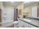 Well-lit bathroom with tub-shower combo, updated vanity, and neutral color scheme at 1 Parker Pond Ct, Durham, NC 27703