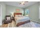 Well-lit bedroom with a plush bed, an area rug, and a relaxing reading chair at 1 Parker Pond Ct, Durham, NC 27703