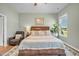 Well-lit bedroom with a plush bed, an area rug, and a relaxing reading chair at 1 Parker Pond Ct, Durham, NC 27703