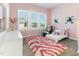 Charming bedroom with large windows, playful décor, and hardwood floors at 1 Parker Pond Ct, Durham, NC 27703