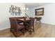 Bright dining area featuring a table with a built in bench, and a view of the stairway and wine cabinet at 1 Parker Pond Ct, Durham, NC 27703