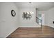 Formal dining area with a decorative chandelier, picture gallery, stairs and wood floors at 1 Parker Pond Ct, Durham, NC 27703