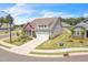 Stylish gray home with a two-car garage, complemented by a lush green lawn, and a sidewalk at 1 Parker Pond Ct, Durham, NC 27703