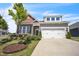 Beautiful home featuring a two-car garage, stone accents, and a well-manicured lawn and landscaping at 1 Parker Pond Ct, Durham, NC 27703
