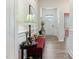 Inviting hallway with decorative bench, lamp, and hallway table at 1 Parker Pond Ct, Durham, NC 27703