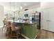 Modern kitchen with white cabinets, stainless steel appliances, and a spacious island with seating at 1 Parker Pond Ct, Durham, NC 27703