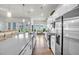 Modern kitchen featuring stainless appliances, white cabinetry, a center island, hardwood floors, and modern lighting at 1 Parker Pond Ct, Durham, NC 27703