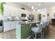 Modern kitchen with white cabinets, gray countertops, stainless appliances, and stylish barstool seating at the island at 1 Parker Pond Ct, Durham, NC 27703