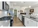 Modern kitchen with stainless steel appliances and access to the dining and living areas at 1 Parker Pond Ct, Durham, NC 27703