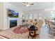 Comfortable living room featuring a fireplace, large TV, plush seating, and a beautiful rug at 1 Parker Pond Ct, Durham, NC 27703