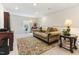 Living room showcasing comfortable seating arrangement, rug, and a view of a window at 1 Parker Pond Ct, Durham, NC 27703