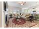 Bright living room featuring a fireplace, large TV, plush seating, a kitchen, and a beautiful rug at 1 Parker Pond Ct, Durham, NC 27703