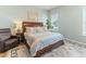 Relaxing main bedroom with a large bed, comfortable seating, and natural light at 1 Parker Pond Ct, Durham, NC 27703