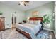 Spacious primary bedroom with an elegant wood bed frame and an en-suite bathroom at 1 Parker Pond Ct, Durham, NC 27703