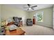 Bright home office with ceiling fan, large window, and comfortable seating at 1 Parker Pond Ct, Durham, NC 27703
