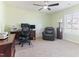 Office space with a desk, computer, chair, and a comfortable leather recliner at 1 Parker Pond Ct, Durham, NC 27703