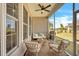 Cozy screened porch with comfortable seating, ceiling fan, and neighborhood views at 1 Parker Pond Ct, Durham, NC 27703