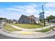 A neighborhood corner view showcasing a gray home, manicured lawns and sidewalks at 1 Parker Pond Ct, Durham, NC 27703