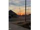 Street showcasing landscaped yards and homes in a quiet neighborhood at sunset at 1 Parker Pond Ct, Durham, NC 27703