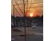 Sunset view of a street showcasing the peaceful neighborhood and well-maintained homes at 1 Parker Pond Ct, Durham, NC 27703