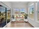 Bright sunroom featuring sliding glass doors, windows, plants and hardwood floors at 1 Parker Pond Ct, Durham, NC 27703