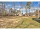 Large grassy backyard offering ample space for outdoor activities, bordered by mature trees, providing privacy at 10 Holden Ct, Youngsville, NC 27596