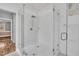 Bathroom featuring a glass enclosed walk-in shower with brushed nickel fixtures and crisp white tile at 10 Holden Ct, Youngsville, NC 27596