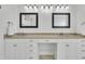 Bathroom showcasing double sink vanity, framed mirrors, granite countertops, and white cabinets at 10 Holden Ct, Youngsville, NC 27596