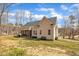 View of the tan house featuring a screened porch, bench, and well-maintained yard at 10 Holden Ct, Youngsville, NC 27596