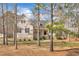 A charming two-story home with stone accents, a welcoming front porch, and mature trees enhancing its curb appeal at 10 Holden Ct, Youngsville, NC 27596