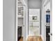 Hallway with hardwood floors leads to the bathroom with a double sink vanity and walk-in closet at 10 Holden Ct, Youngsville, NC 27596