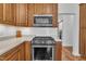 Close-up of kitchen with stainless steel oven and range, featuring white subway tile backsplash and shaker cabinets at 10 Holden Ct, Youngsville, NC 27596