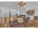Open concept living room featuring hardwood floors, comfortable seating, and seamless flow to the dining and kitchen areas at 10 Holden Ct, Youngsville, NC 27596