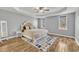 Bedroom featuring tray ceilings, wood floors, with lots of natural light and neutral color palette at 10 Holden Ct, Youngsville, NC 27596