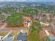 Aerial view of a home nestled within a lush, wooded neighborhood with mature trees and quiet streets at 105 Shawnee Drive, Louisburg, NC 27549