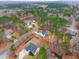 Aerial view of a wooded neighborhood with homes nestled among mature trees and quiet streets at 105 Shawnee Drive, Louisburg, NC 27549
