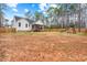Spacious fenced backyard with a screened porch, mature trees, and a playset at 105 Shawnee Drive, Louisburg, NC 27549