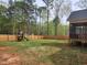 Spacious backyard with a wooden fence and a play set, ideal for outdoor activities and Gathering fun at 105 Shawnee Drive, Louisburg, NC 27549