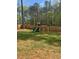 A backyard featuring a wooden playset with a slide and swings, perfect for entertainment at 105 Shawnee Drive, Louisburg, NC 27549